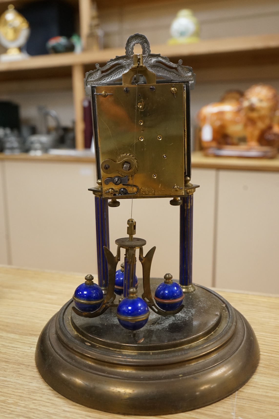 A Jahresuhrenfabrik anniversary clock with blue-enamelled dial, under glass dome, 32cm